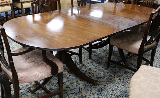 A Regency style mahogany two pillar dining table, one spare leaf W.216cm